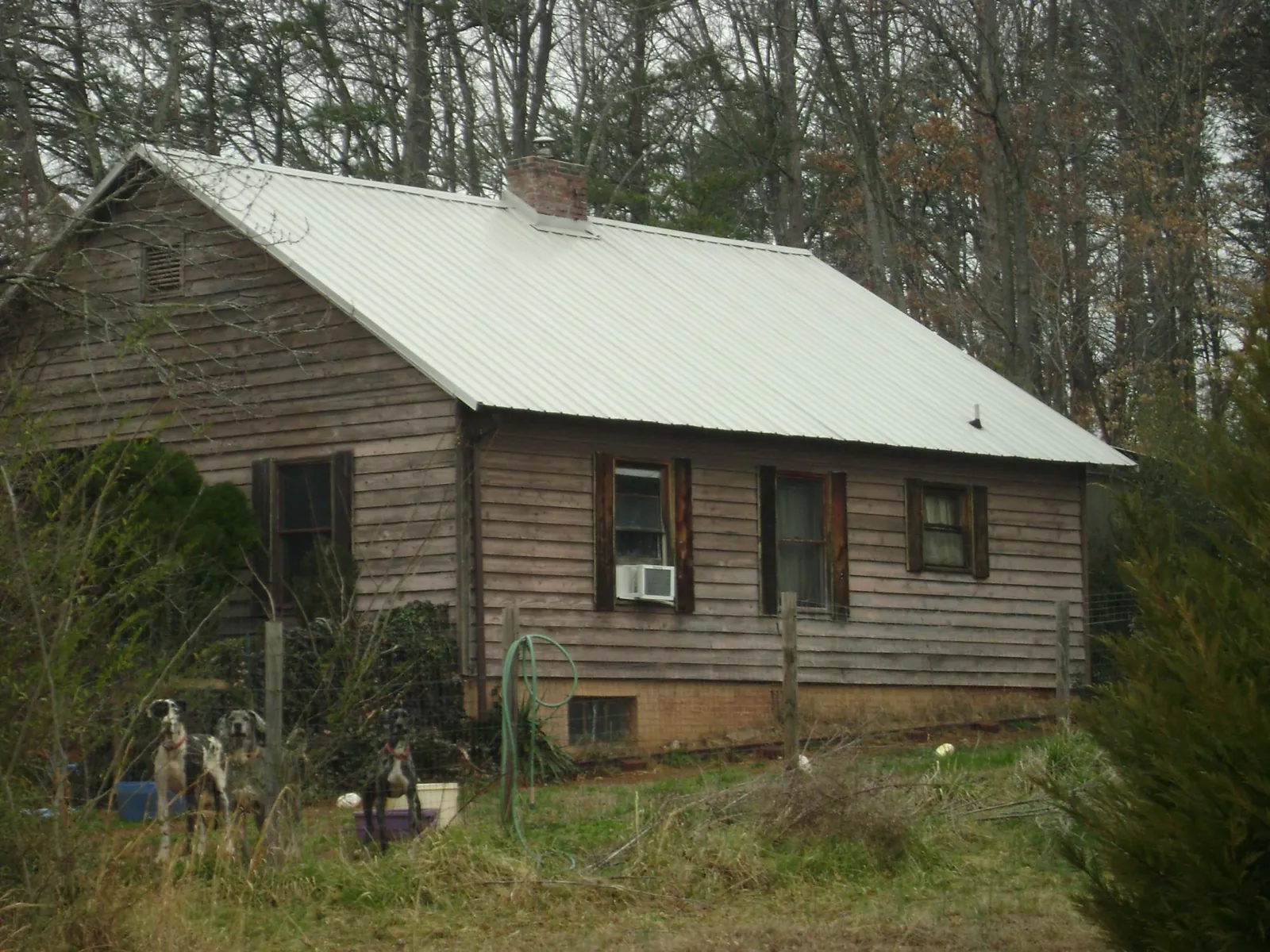 White metal roof on an old wood sided farmhouse, from a Metal Roof Installation job in Nelsonia